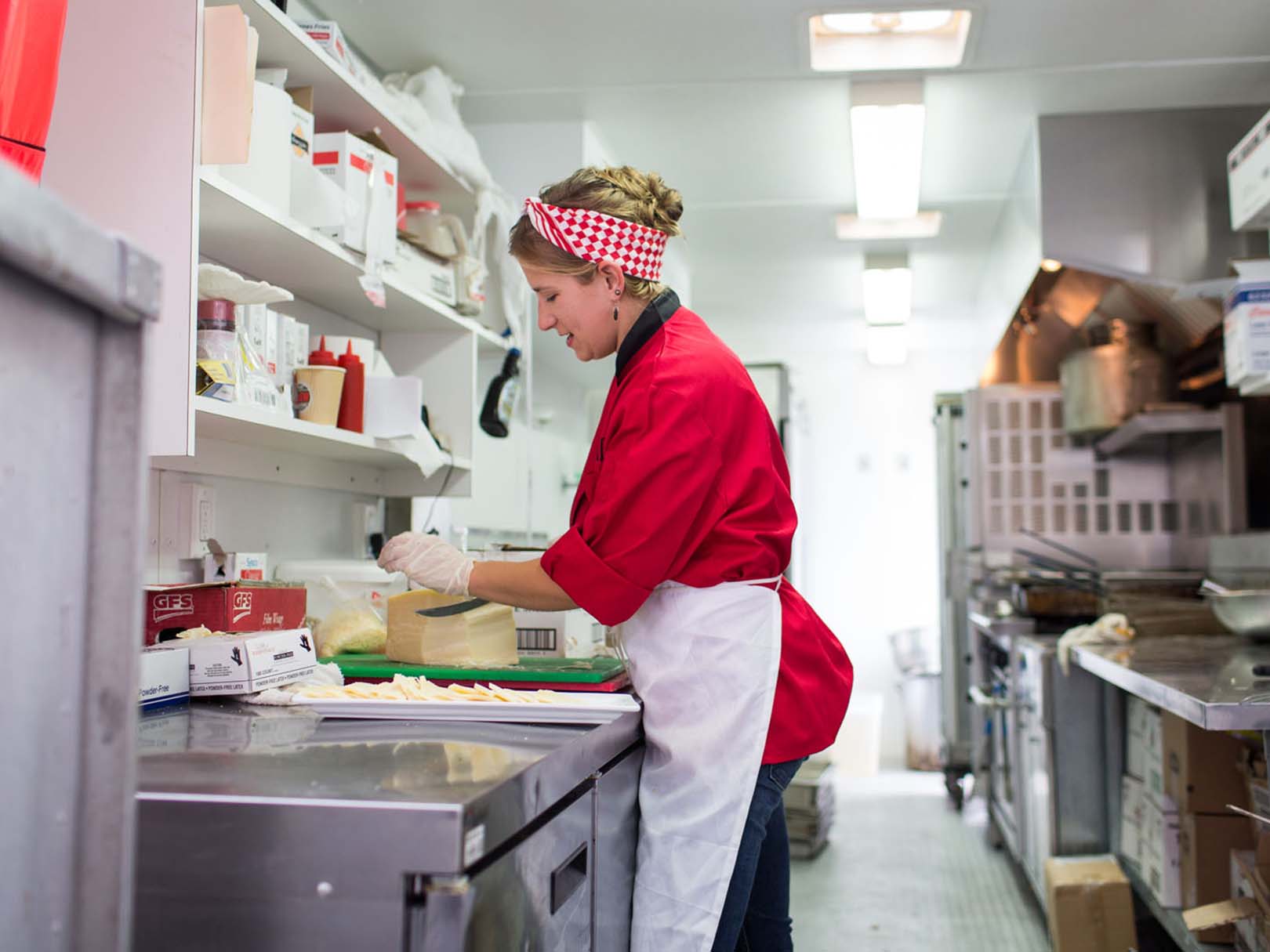 woman prepping food in mobile kitchen